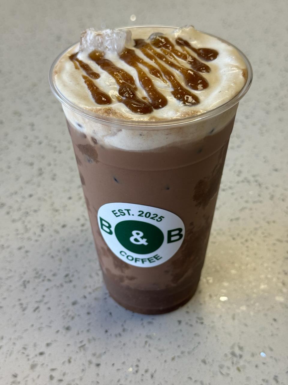Banana Mocha Latte with whipped cream and caramel drizzle